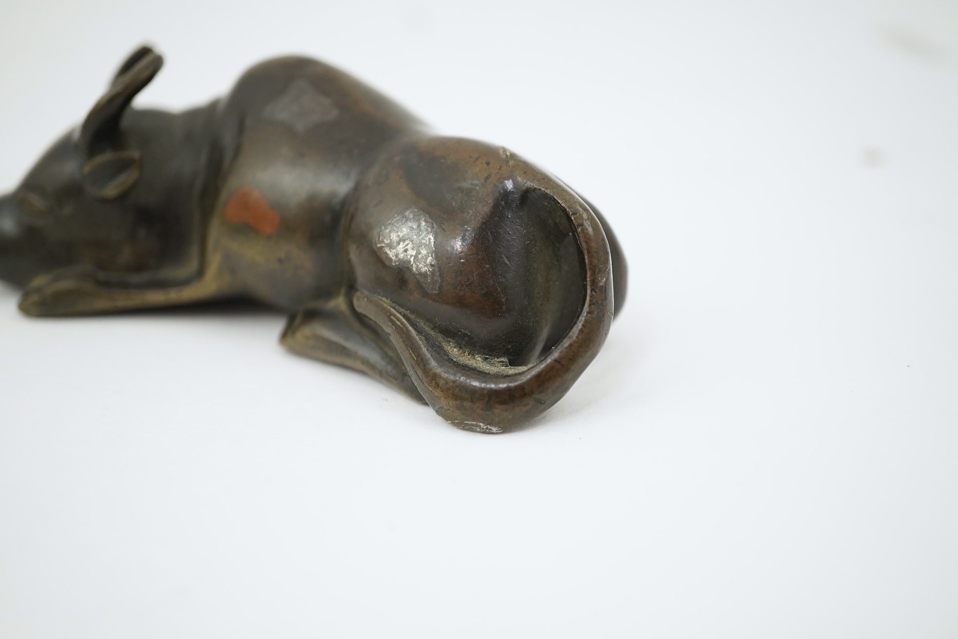 A Chinese bronze and mixed metal buffalo scroll weight, 19th century